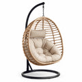 Sillón colgante de ratán sintético con cojín beige y estructura de acero