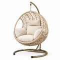 Sillón colgante de ratán sintético con cojines beige